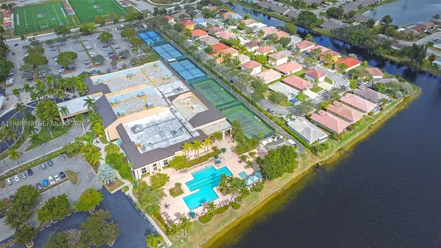 an aerial view of a residential houses with yard