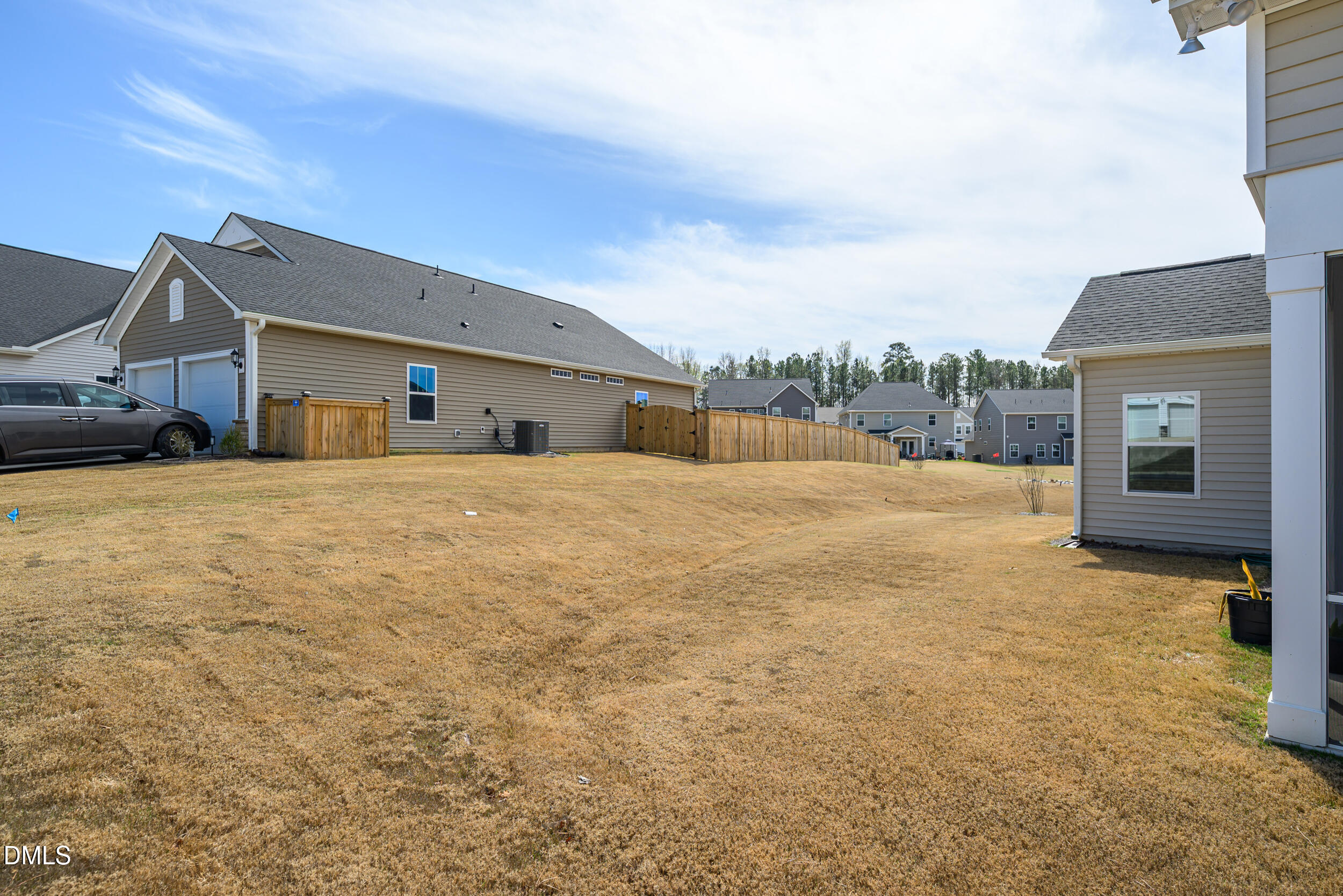 411 North Maple Walk Garner, NC 27529 - Photo 27 of 41 a large house with a large parking space and a large tree