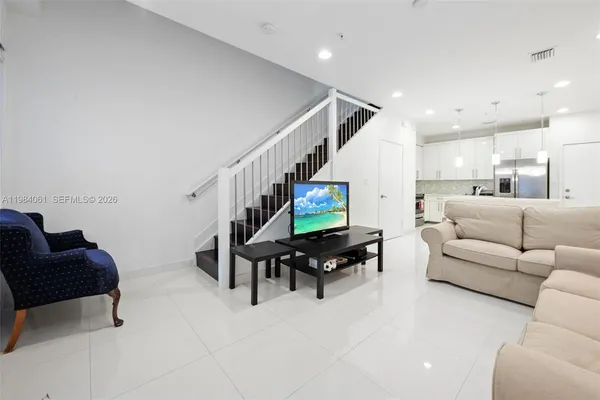 a living room with furniture and wooden floor