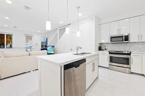 a kitchen with a sink stove and microwave
