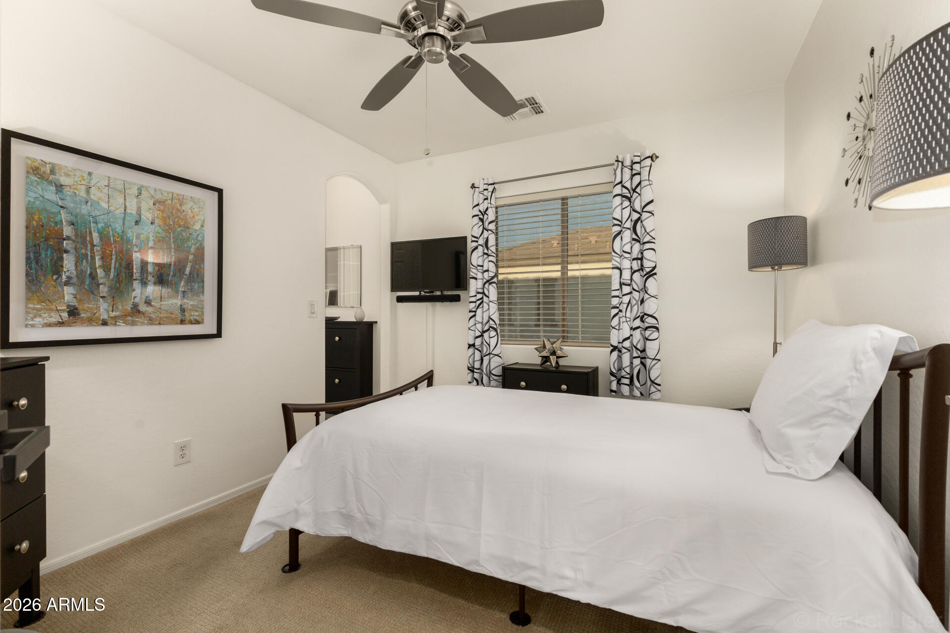 4676 East Redfield Road Gilbert, AZ 85234 - Photo 17 of 32 a bedroom with a bed and a painting on the wall