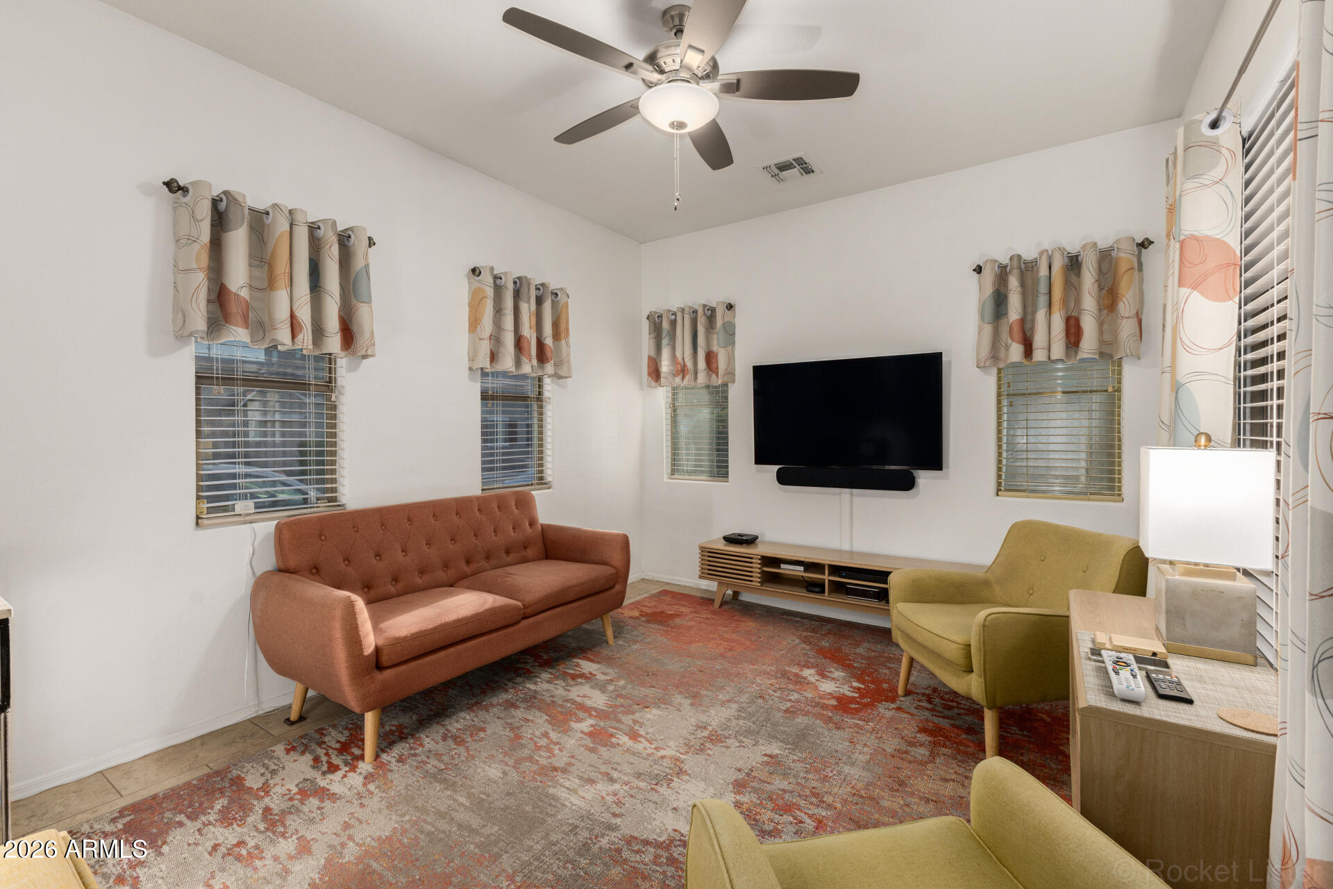4676 East Redfield Road Gilbert, AZ 85234 - Photo 3 of 32 a living room with furniture and a flat screen tv