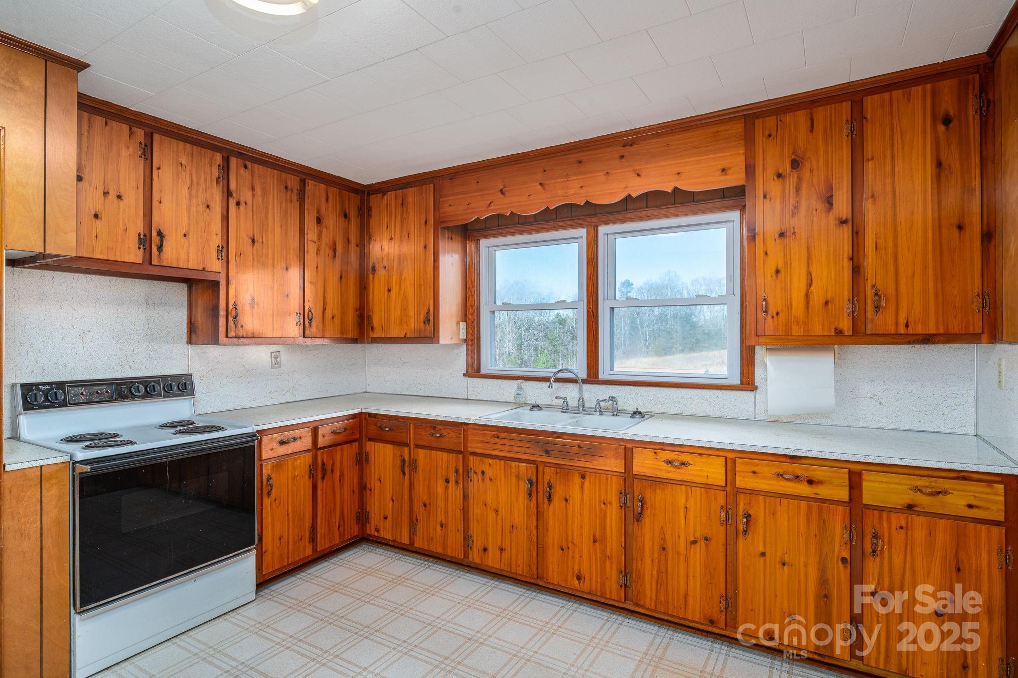 897 Calloway Road Lincolnton, NC 28092 - Photo 16 of 40 a kitchen with stainless steel appliances granite countertop wooden cabinets a sink and a window