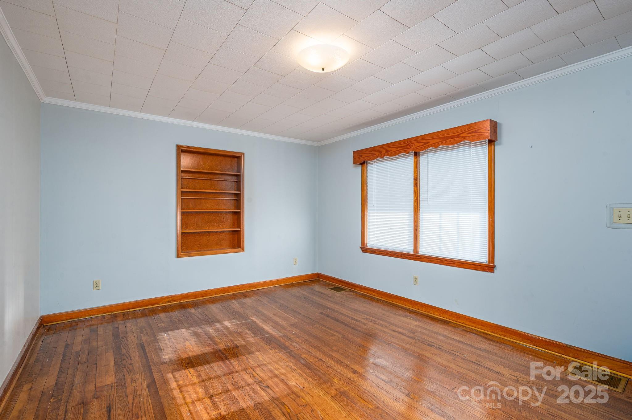 897 Calloway Road Lincolnton, NC 28092 - Photo 20 of 40 a view of an empty room with wooden floor and a window