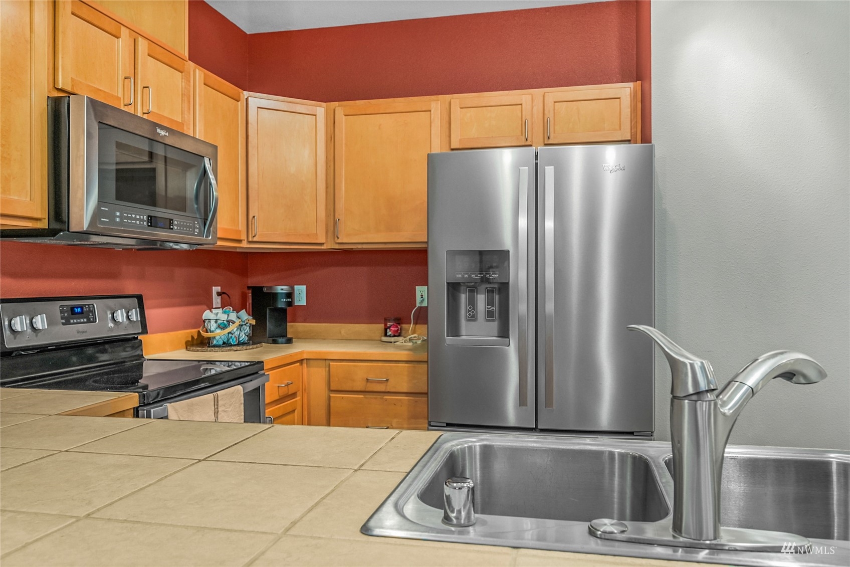14335 Simonds Road Northeast, Unit A302 Kirkland, WA 98034 - Photo 11 of 25 a kitchen with stainless steel appliances granite countertop a refrigerator a stove and a sink with granite countertops