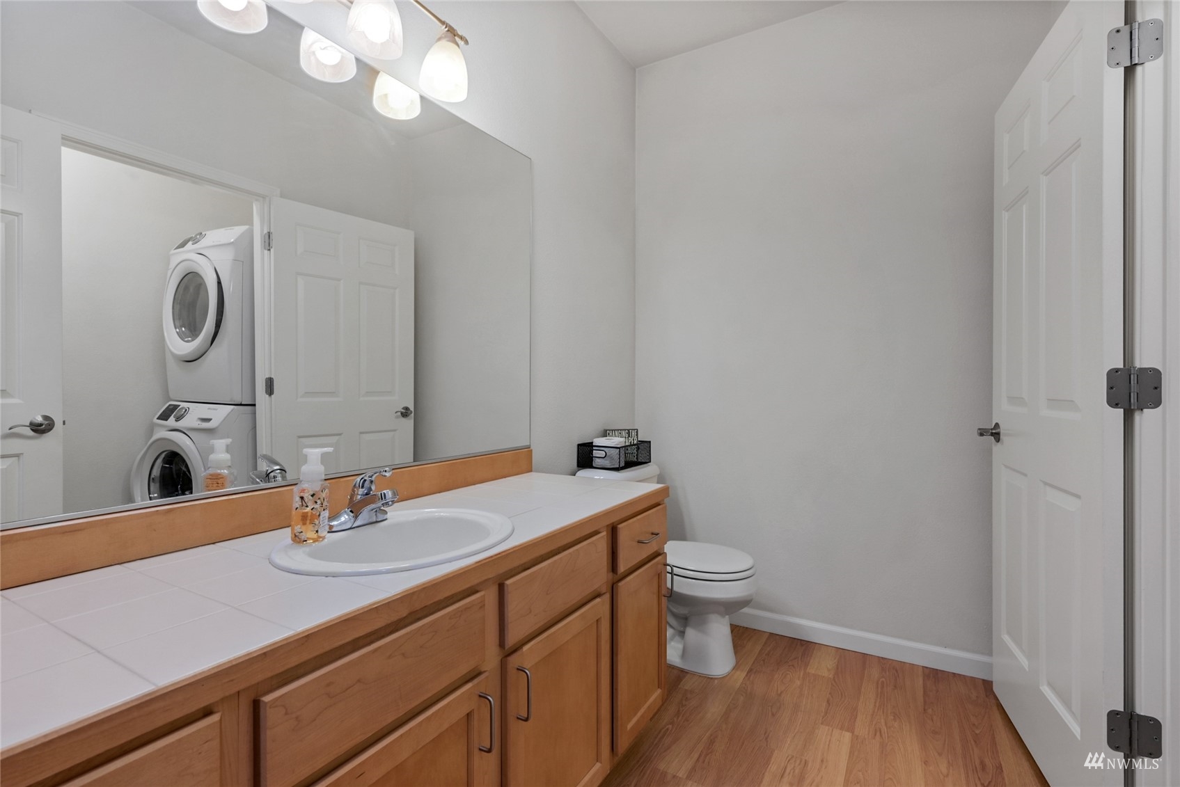 14335 Simonds Road Northeast, Unit A302 Kirkland, WA 98034 - Photo 13 of 25 a bathroom with a sink a toilet and a mirror
