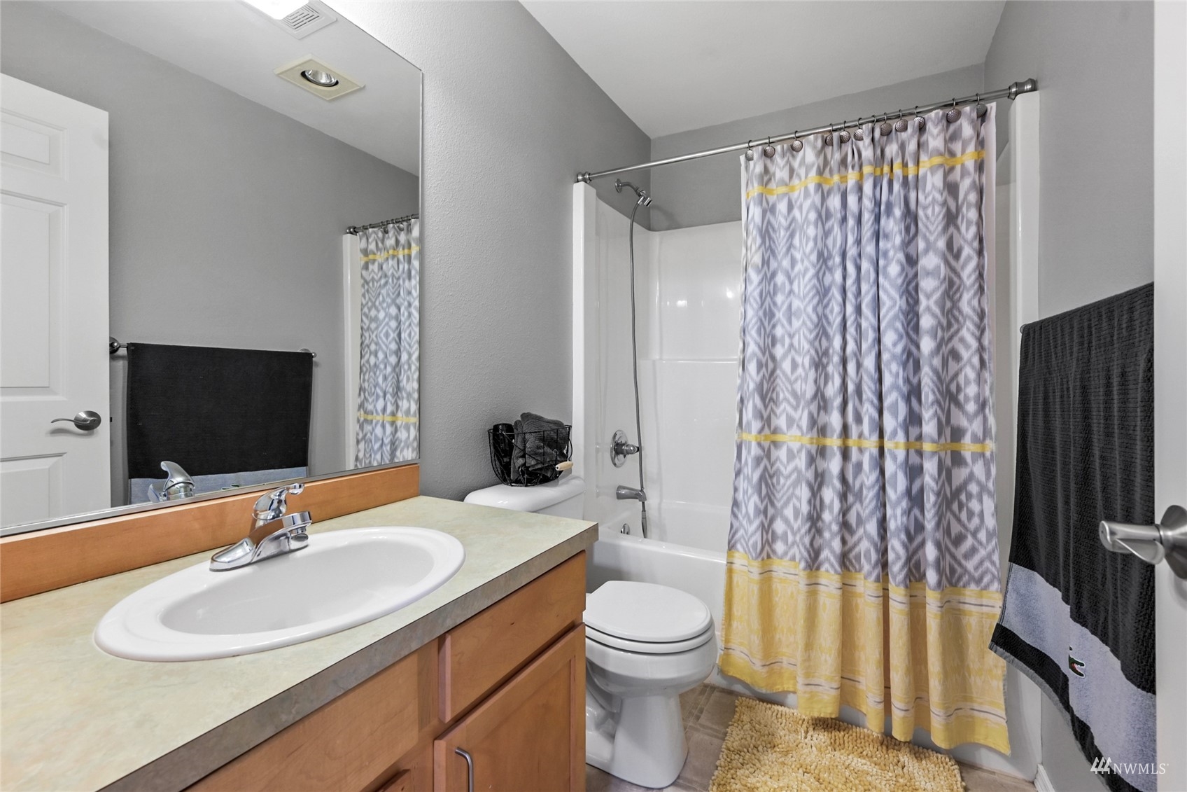 14335 Simonds Road Northeast, Unit A302 Kirkland, WA 98034 - Photo 18 of 25 a bathroom with a sink toilet a mirror and shower curtain