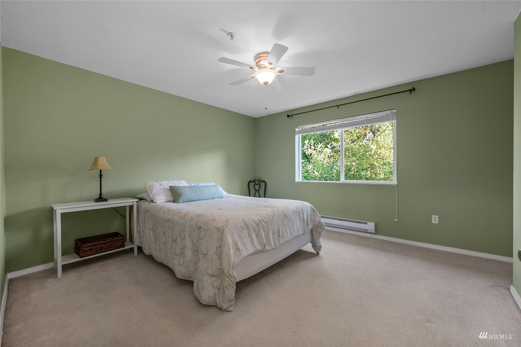 14335 Simonds Road Northeast, Unit A302 Kirkland, WA 98034 - Photo 20 of 25 a bedroom with a bed and a chandelier