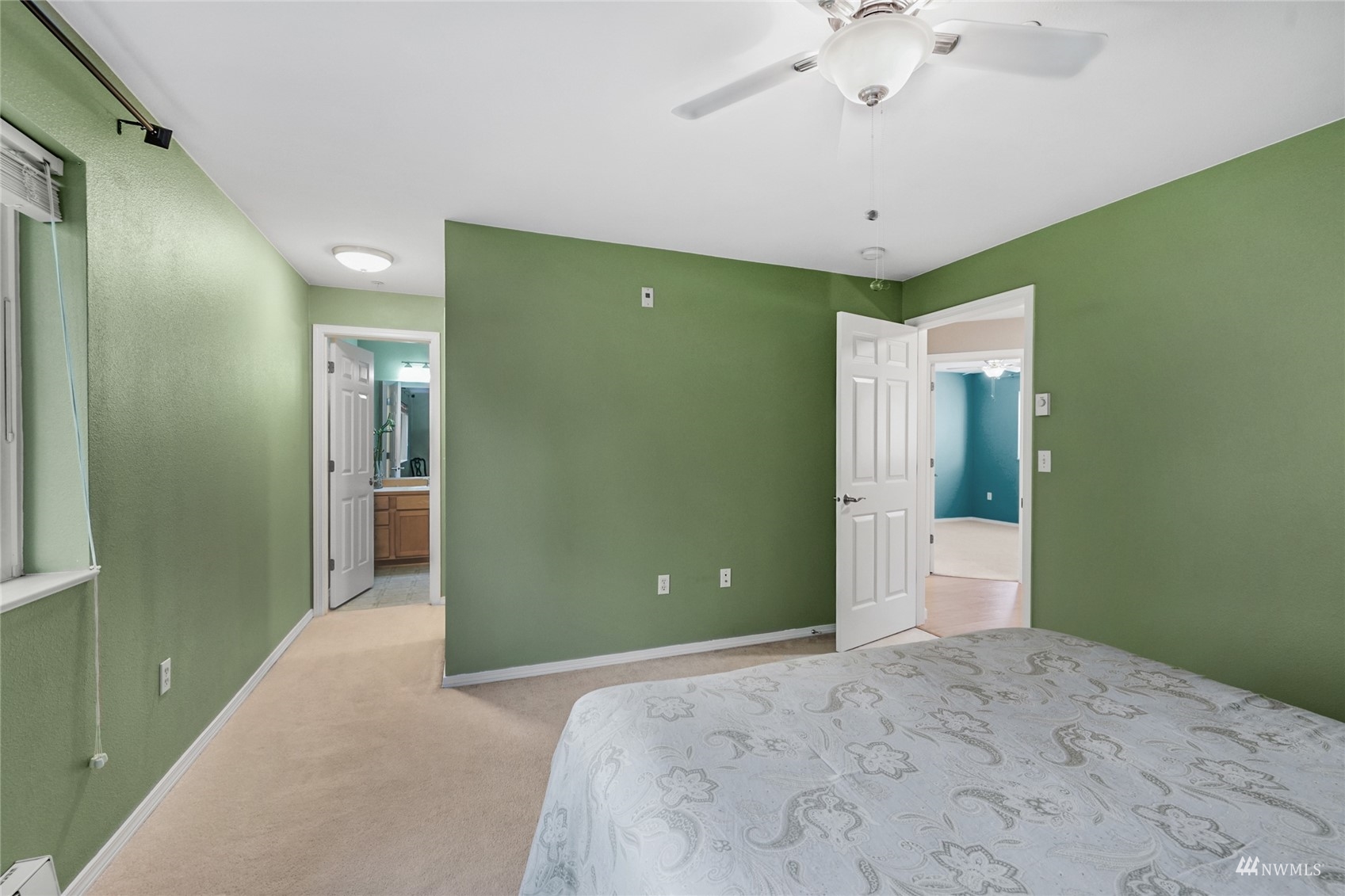 14335 Simonds Road Northeast, Unit A302 Kirkland, WA 98034 - Photo 21 of 25 a bedroom with a bed and a chandelier