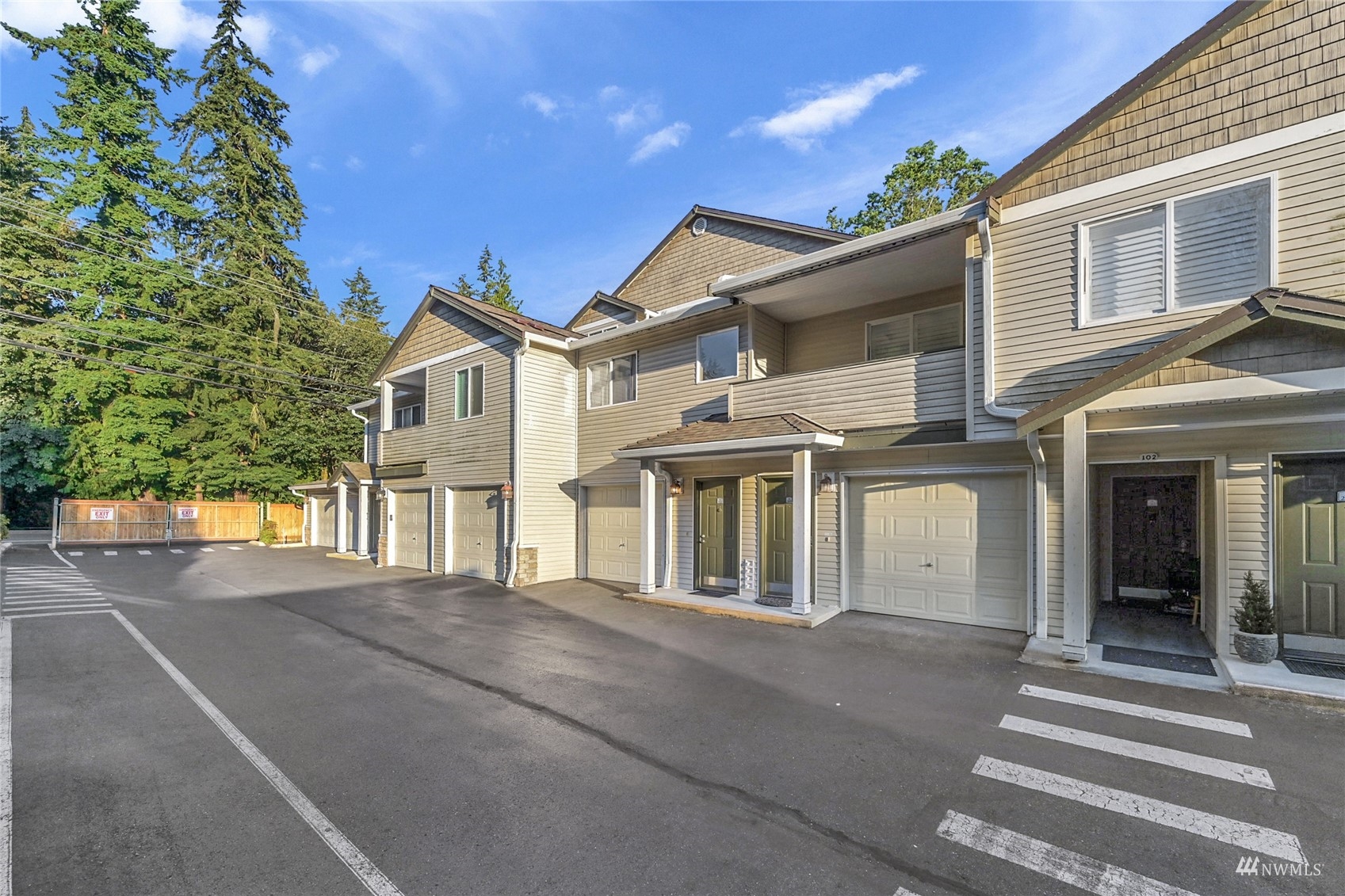 14335 Simonds Road Northeast, Unit A302 Kirkland, WA 98034 - Photo 3 of 25 a front view of a house with a yard