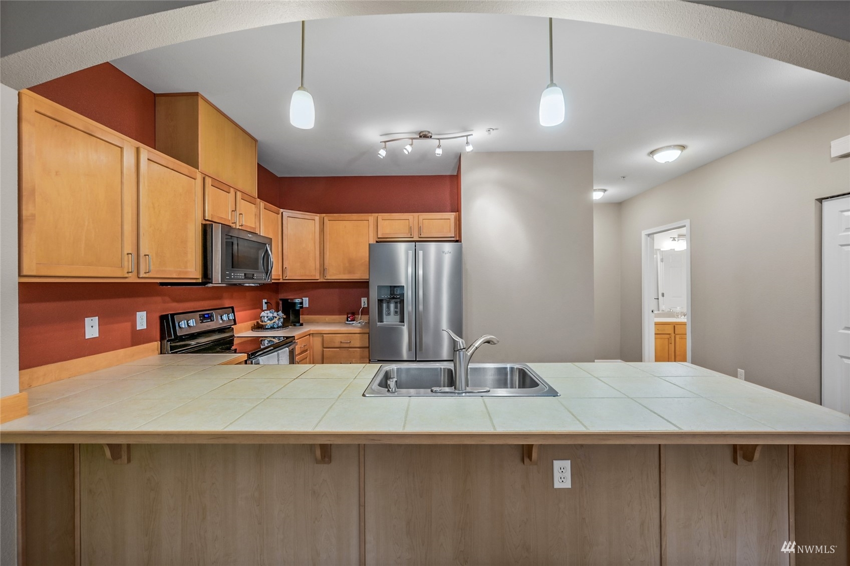 14335 Simonds Road Northeast, Unit A302 Kirkland, WA 98034 - Photo 8 of 25 a kitchen with stainless steel appliances a sink stove and cabinets