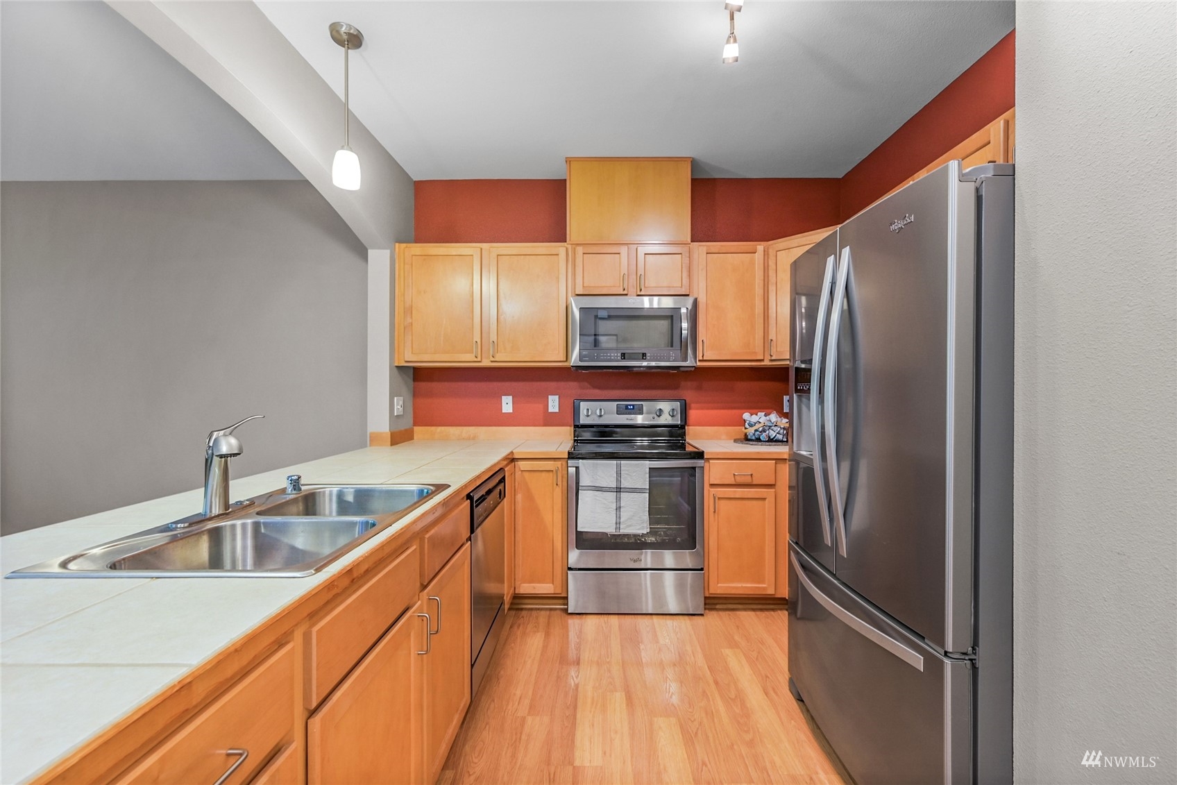 14335 Simonds Road Northeast, Unit A302 Kirkland, WA 98034 - Photo 9 of 25 a kitchen with stainless steel appliances granite countertop a refrigerator and a sink