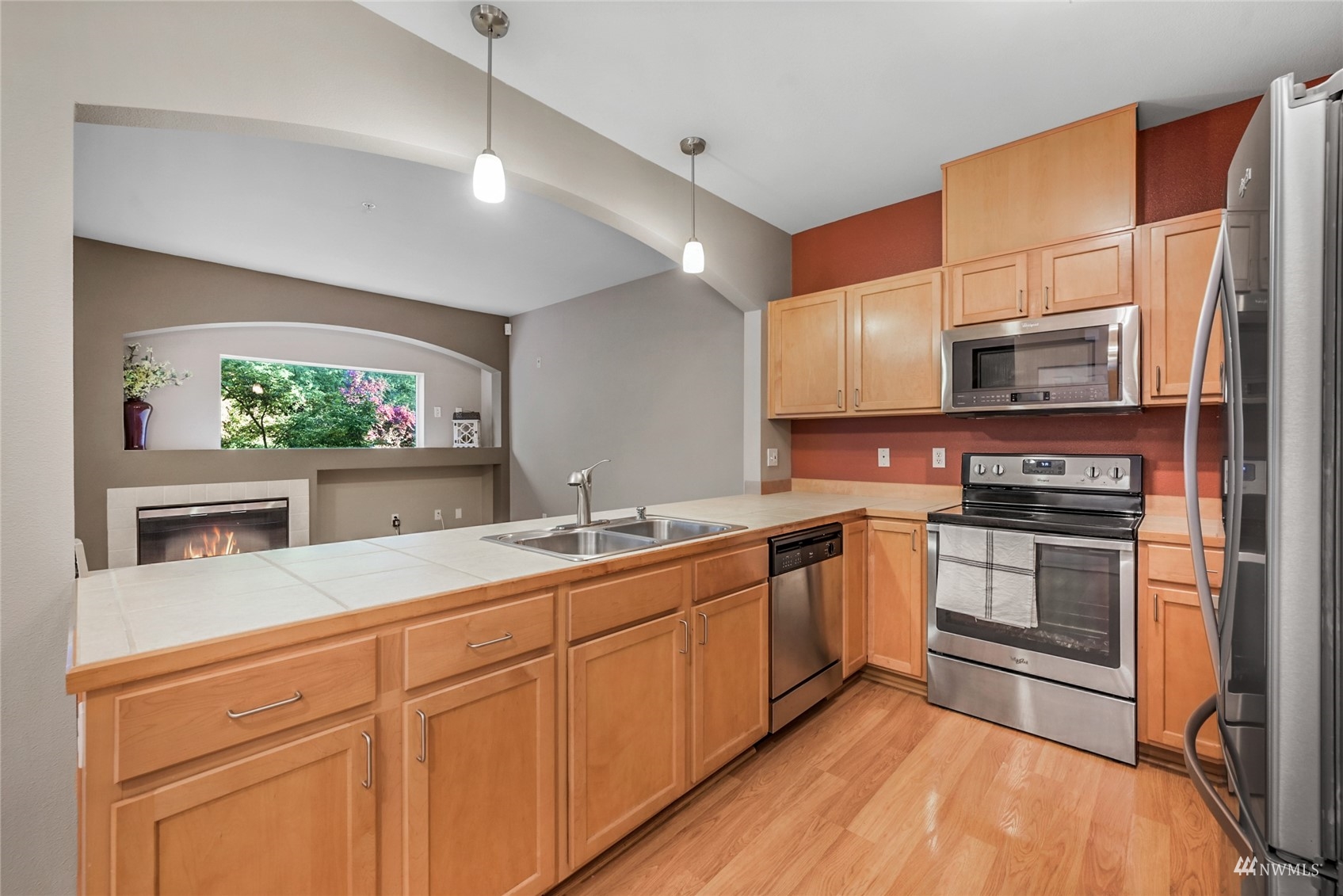 14335 Simonds Road Northeast, Unit A302 Kirkland, WA 98034 - Photo 10 of 25 a kitchen with stainless steel appliances granite countertop a stove a sink and a microwave