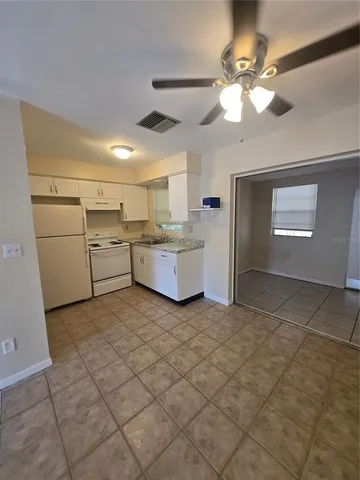 a view of a kitchen with furniture and chandelier