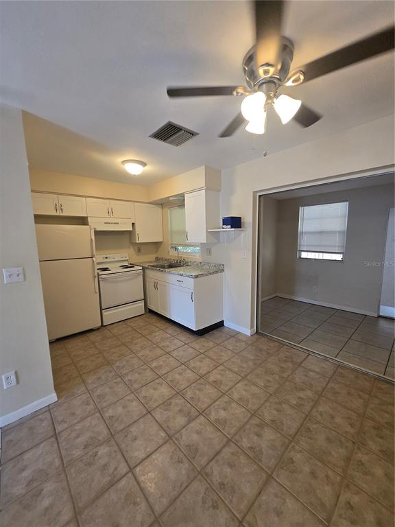 830 Highland Avenue, Unit 2 Largo, FL 33770 - Photo 3 of 13 a view of a kitchen with furniture and chandelier