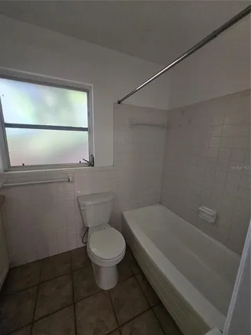 a bathroom with a toilet and a bathtub