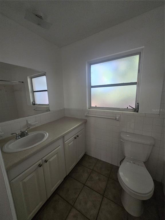830 Highland Avenue, Unit 2 Largo, FL 33770 - Photo 7 of 13 a bathroom with a toilet sink and mirror