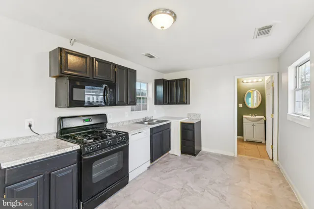 a backyard of a house with lots of green space and plants