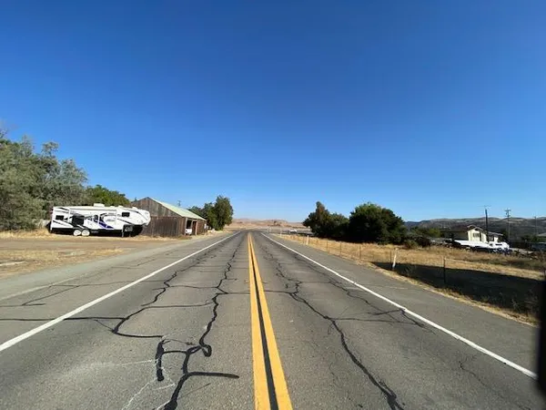 a view of a street with cars on road