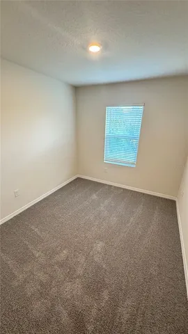 an empty room with a empty space and windows