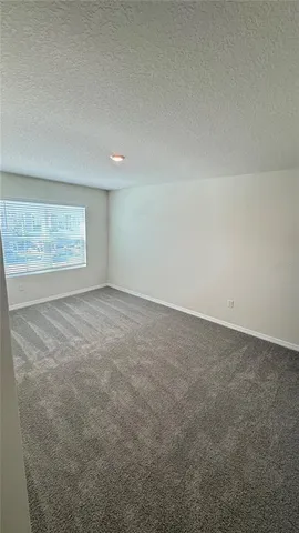 a spacious bathroom with a granite countertop sink a toilet and a tub