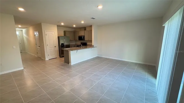 a large kitchen with a sink and a stove top oven