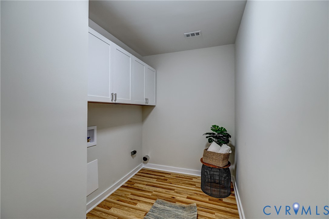 12301 Beaver Point Drive Midlothian, VA 23112 - Photo 16 of 24 a room with a potted plant and wooden floor