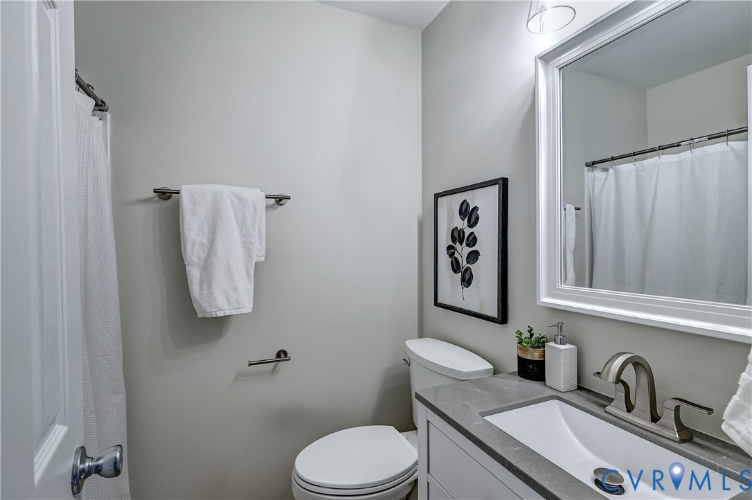 12301 Beaver Point Drive Midlothian, VA 23112 - Photo 20 of 24 a white toilet sitting next to a bathroom sink