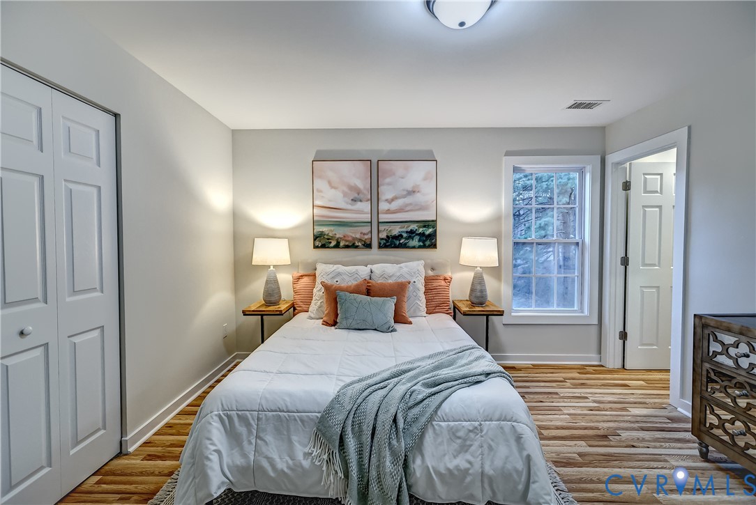 12301 Beaver Point Drive Midlothian, VA 23112 - Photo 21 of 24 a bed room with a bed and a night stand
