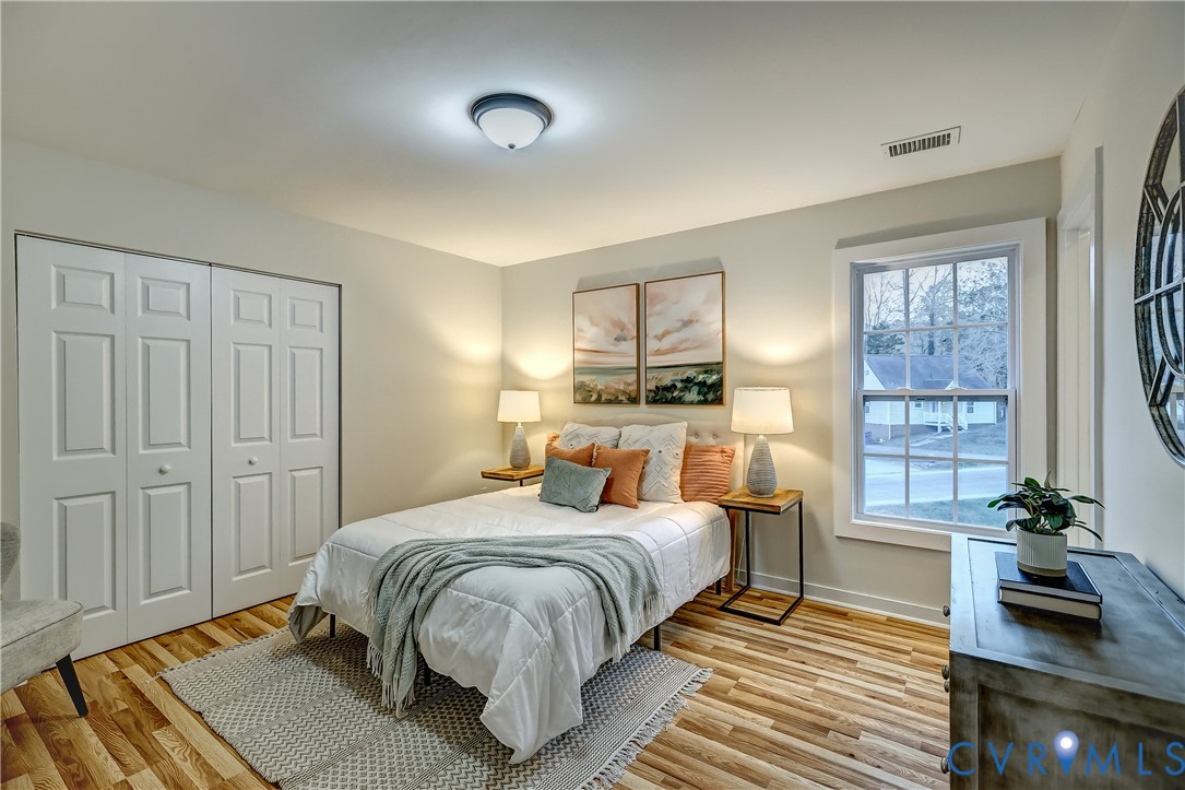 12301 Beaver Point Drive Midlothian, VA 23112 - Photo 22 of 24 a bedroom with a bed and wooden floor