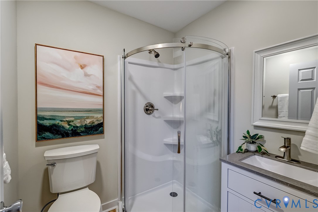 12301 Beaver Point Drive Midlothian, VA 23112 - Photo 24 of 24 a bathroom with a sink a mirror a toilet and shower