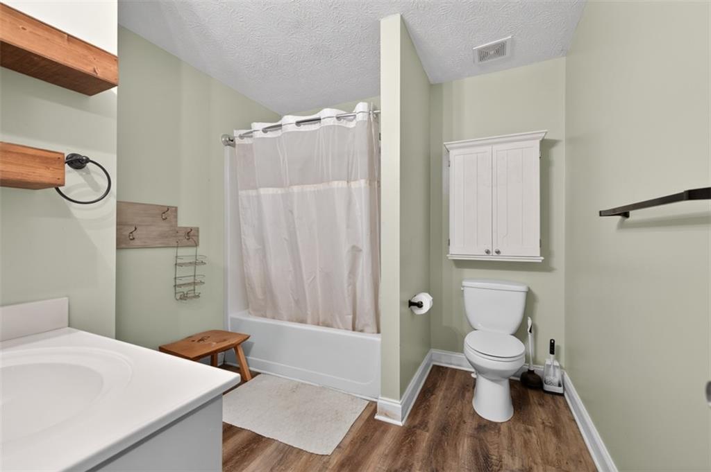 89 Katie Spring Lane Jefferson, GA 30549 - Photo 26 of 63 a bathroom with a sink a toilet and shower