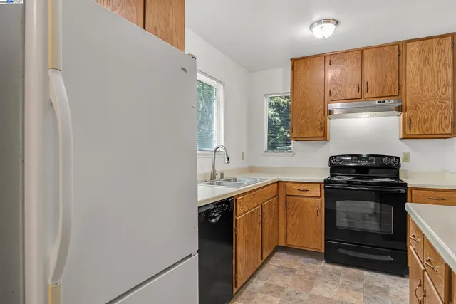 a utility room with cabinets washer and dryer