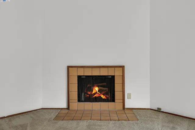 a view of an empty room with a fireplace