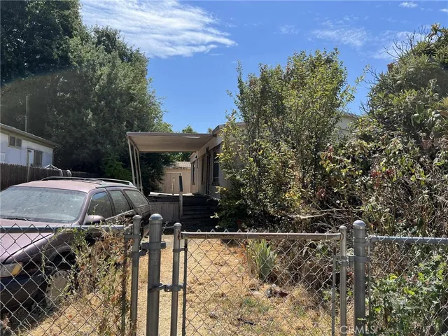 a front view of a house with yard and mountain view