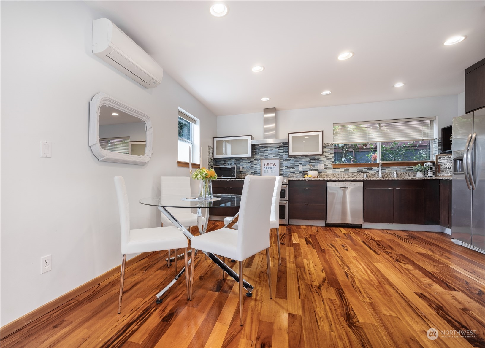 562 Galer Street, Unit A Seattle, WA 98109 - Photo 13 of 30 a view of a dining room with furniture a rug and wooden floor