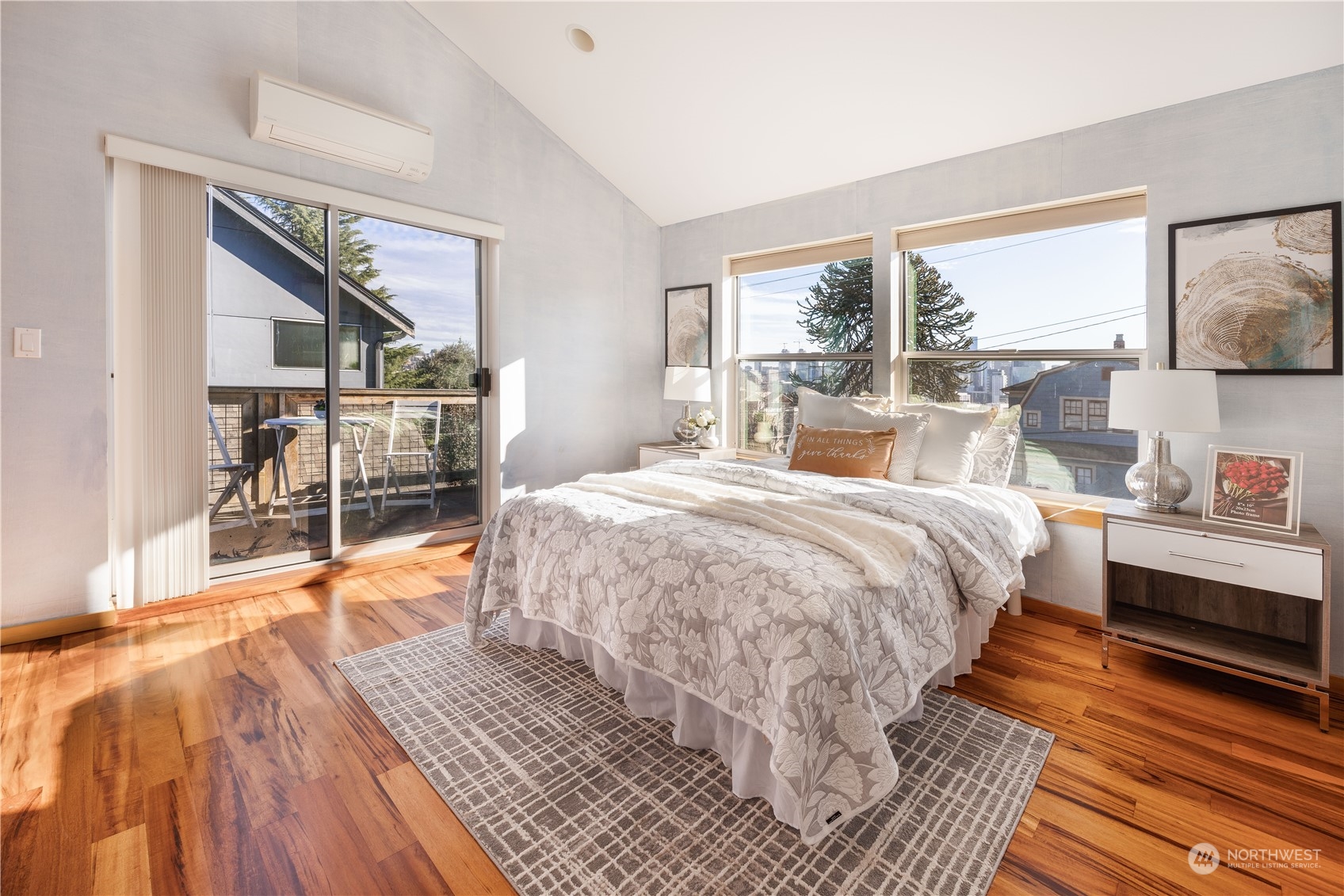 562 Galer Street, Unit A Seattle, WA 98109 - Photo 20 of 30 a bedroom with a bed a large window with wooden floor and garden view