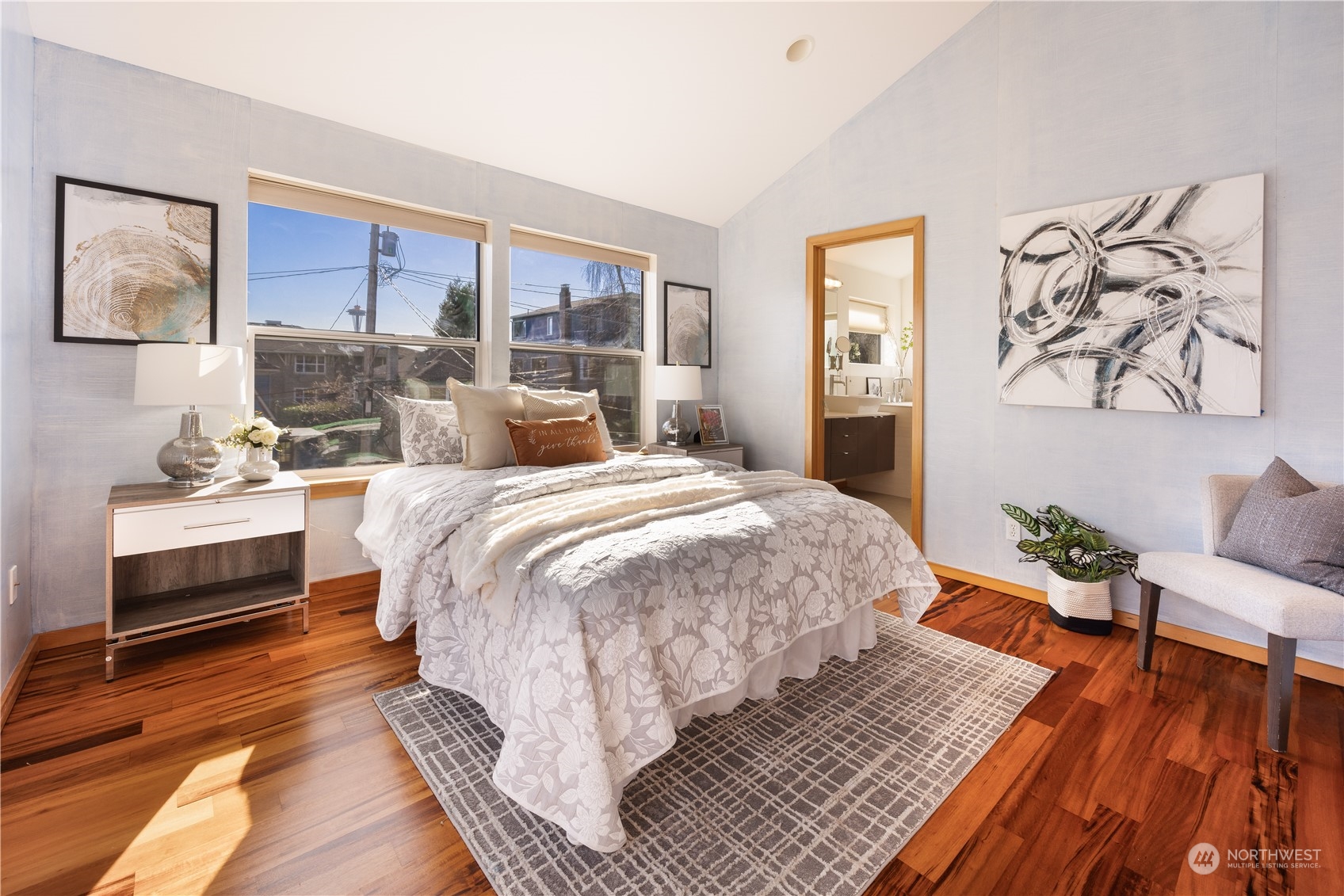 562 Galer Street, Unit A Seattle, WA 98109 - Photo 21 of 30 a large bedroom with a bed and wooden floor