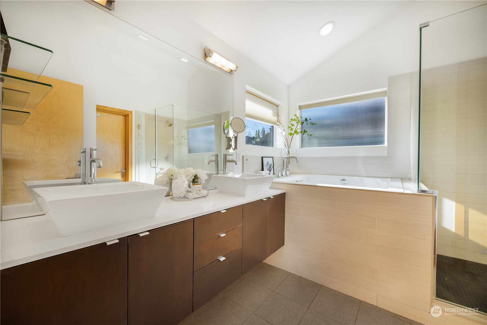 562 Galer Street, Unit A Seattle, WA 98109 - Photo 22 of 30 a bathroom with a sink a large mirror and a bathtub