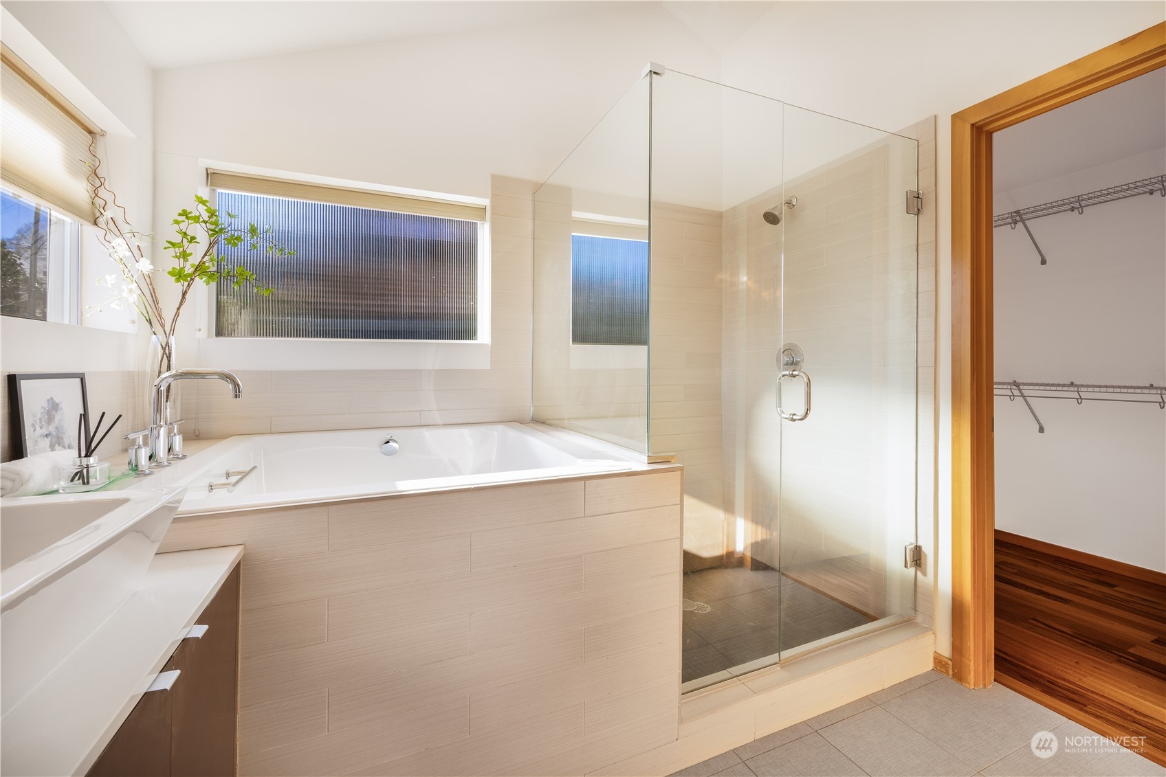 562 Galer Street, Unit A Seattle, WA 98109 - Photo 24 of 30 a bathroom with a tub sink shower and mirror