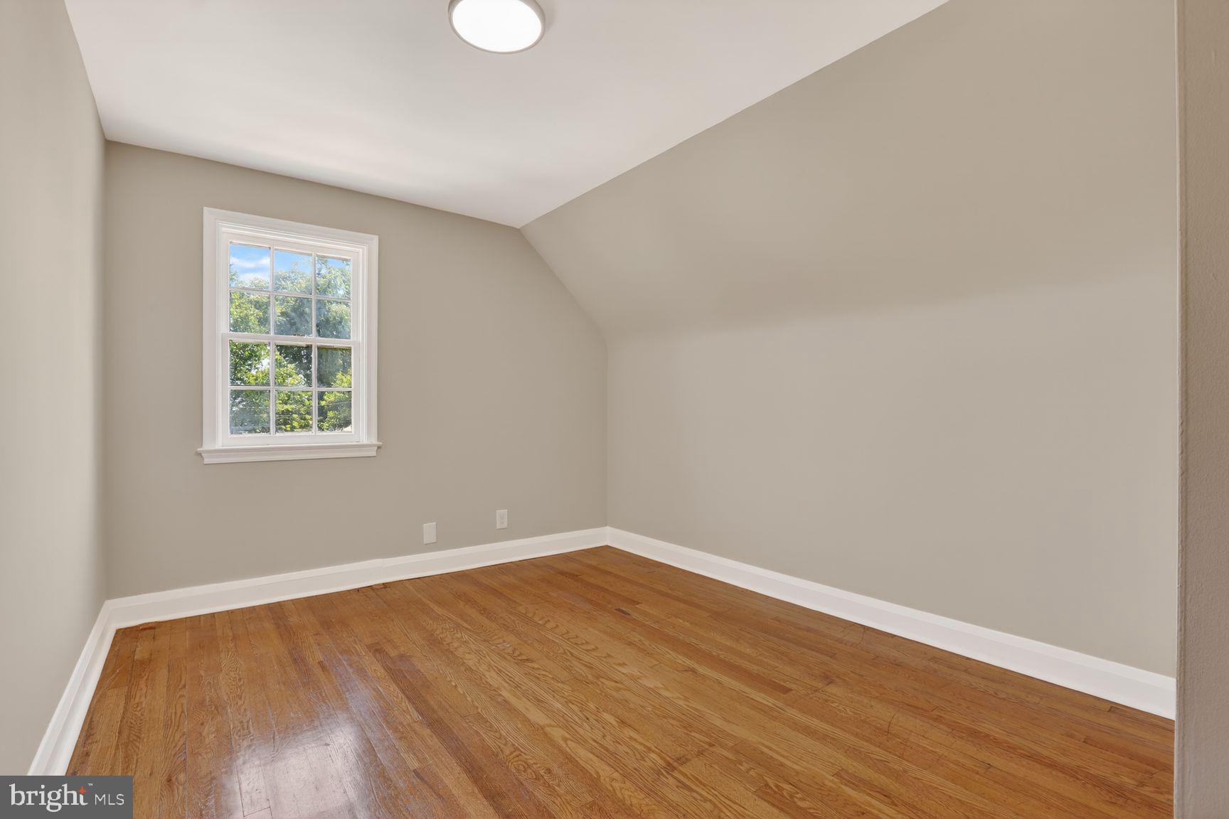 315 East Cold Spring Lane Baltimore, MD 21212 - Photo 15 of 25 wooden floor in an empty room with a window