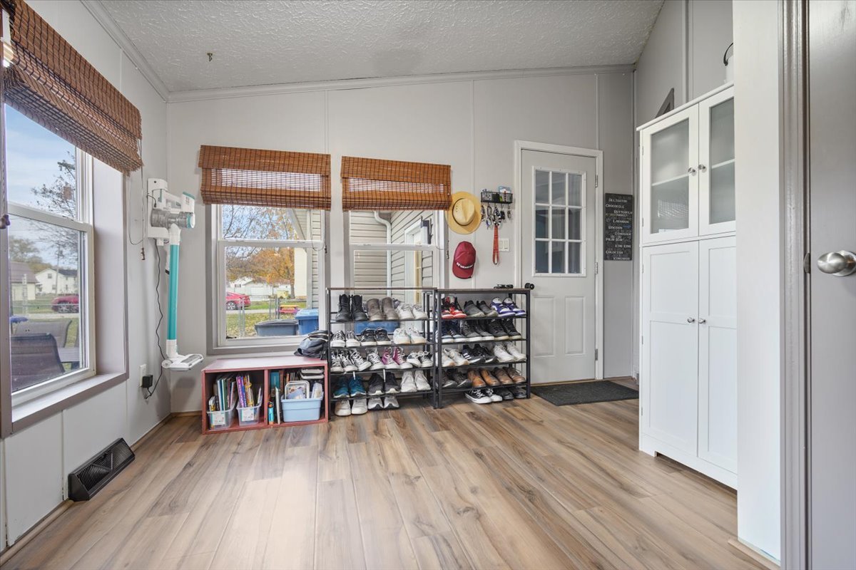 602 West 6th Street Minonk, IL 61760 - Photo 12 of 32 a room with wooden floor a large window and furniture