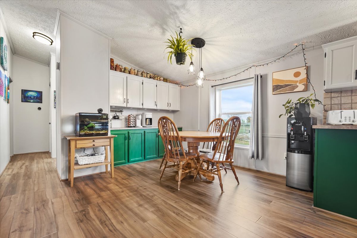 602 West 6th Street Minonk, IL 61760 - Photo 8 of 32 a kitchen with kitchen island wooden floors appliances and cabinets