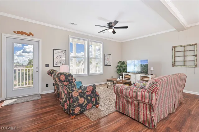 a living room with furniture a ceiling fan and a window