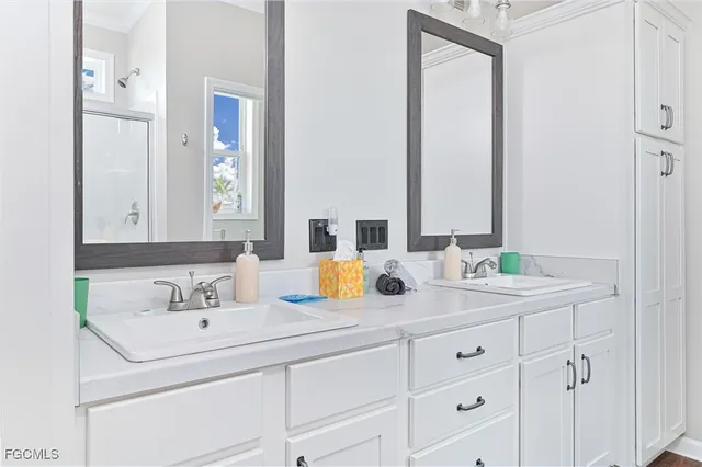 a bathroom with double sink and a mirror
