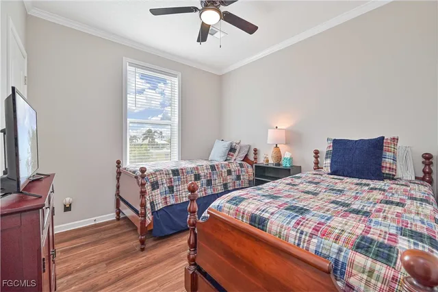 a bedroom with two beds and painting on the wall
