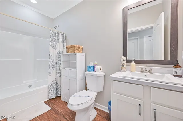 a bathroom with a sink toilet vanity and shower