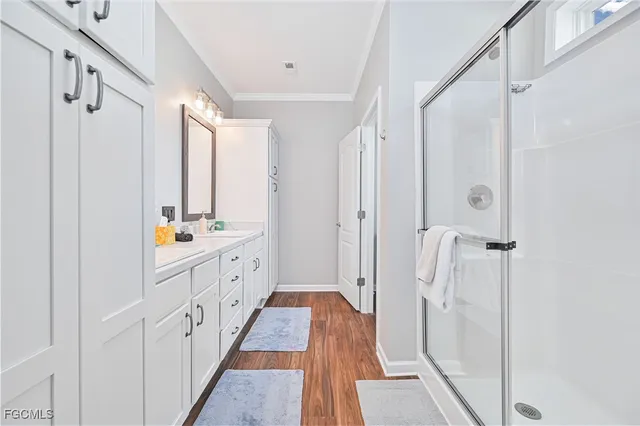 a bathroom with a double vanity sink and mirror