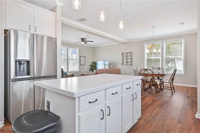 a kitchen with a table chairs and refrigerator