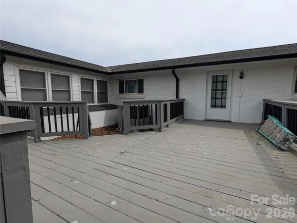 an empty room with wooden floor and fence